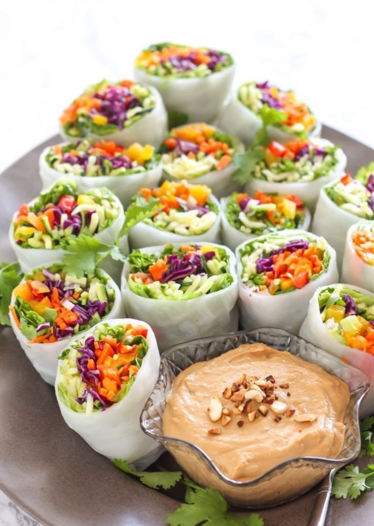 Packed with veggies fresh herbs and sweet mango these Loaded Veggie Summer Rolls with Cashew Tahini Dip are a perfect healthy summer appetizer