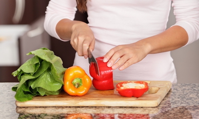 close up woman cutting veg hands and torso only 87218485 copy